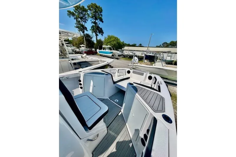 Slide: The Image of 2024 Yamaha Boats 222 FSH Sport E interior, showcasing seating and deck layout. - 12