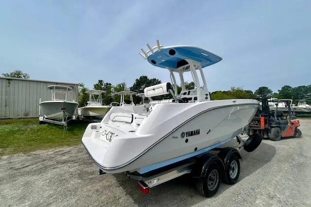 Slide: The Image of 2024 Yamaha Boats 222 FSH Sport E on trailer, parked outdoors. - 4