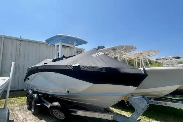 Slide: The Image of 2024 Yamaha Boats 222 FSH Sport E on trailer, covered, outdoors. - 5