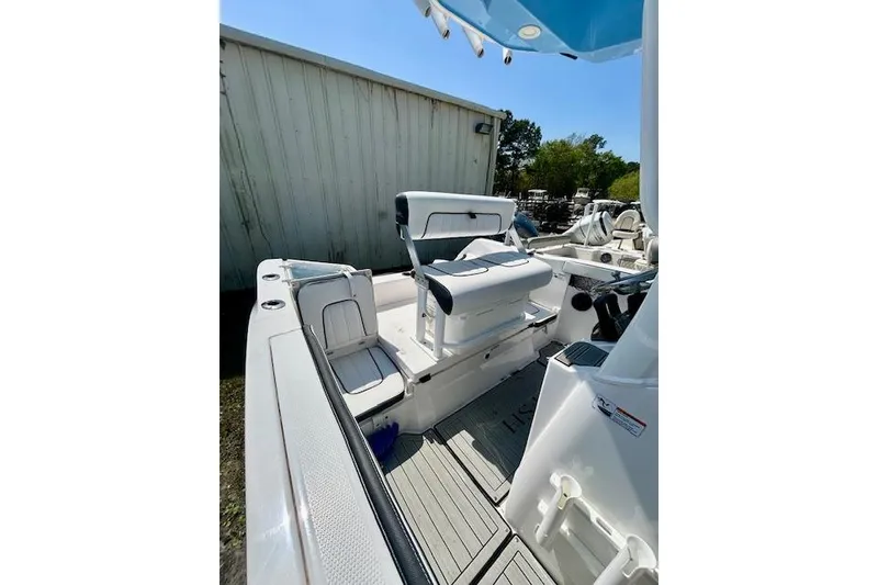 Slide: The Image of 2024 Yamaha Boats 222 FSH Sport E interior with seating and console. - 8