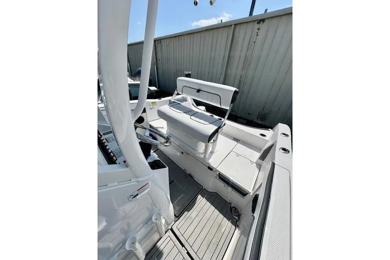 Slide: The Image of 2024 Yamaha Boats 222 FSH Sport E interior with seating and deck view. - 9