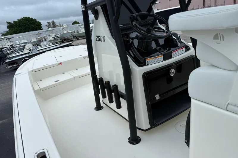 Slide: The Image of 2026 Pathfinder 2500 Hybrid boat interior with steering console and seating. - 12