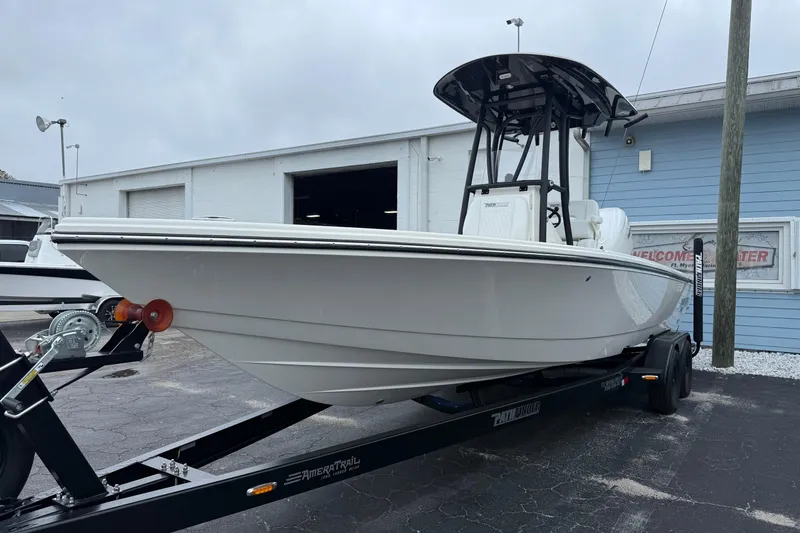 Slide: The Image of 2026 Pathfinder 2500 Hybrid boat on trailer outside a building. - 14