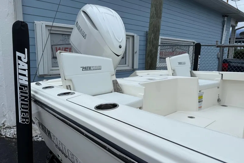 Slide: The Image of 2026 Pathfinder 2500 Hybrid boat with Yamaha engine, docked near a blue building. - 9