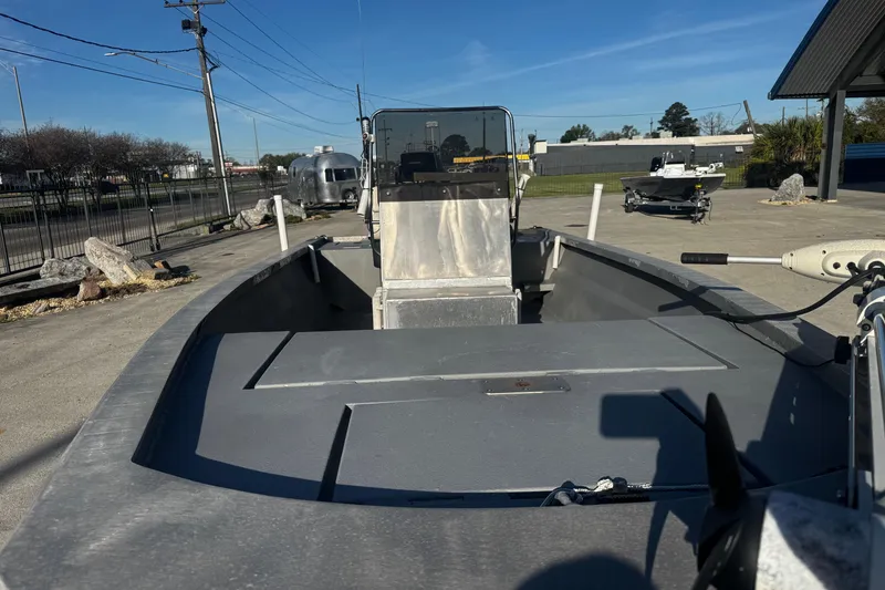Slide: The Image of Custom Charles Leonard 21 boat, 2004 model, parked outdoors on a sunny day. - 10