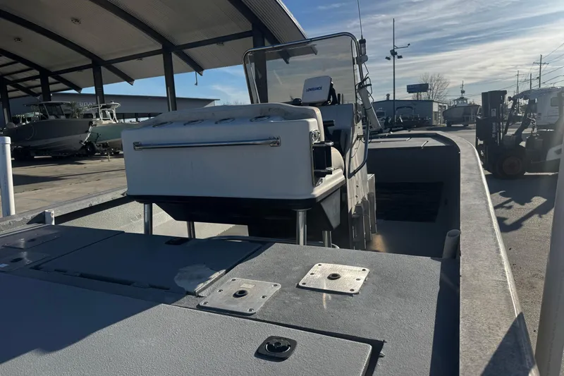 Slide: The Image of Custom Charles Leonard 21 boat, 2004 model, docked under a covered area. - 11