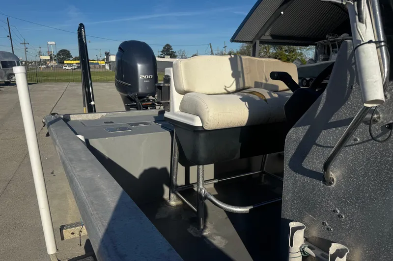 Slide: The Image of Custom Charles Leonard 21 boat, 2004 model, with Yamaha 200 engine, parked outdoors. - 13