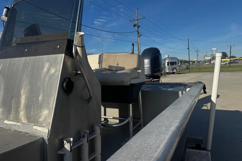 Slide: The Image of Aluminum boat with console and seat, Custom Charles Leonard 21, 2004 model, parked outdoors. - 15