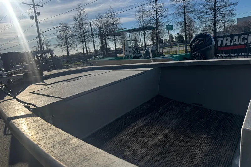 Slide: The Image of Open deck of a 2004 Custom Charles Leonard 21 boat under sunlight. - 16