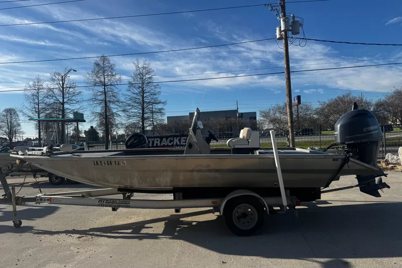 Slide: The Image of Custom Charles Leonard 21 boat on trailer, parked outdoors, clear sky background. - 6