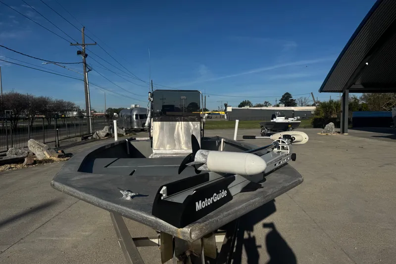 Slide: The Image of Custom Charles Leonard 21 boat, 2004 model, with MotorGuide trolling motor in a sunny outdoor setting. - 8