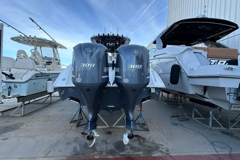 Slide: The Image of 2017 Cape Horn 32 T boat with twin Yamaha 300 engines, docked between other boats. - 4