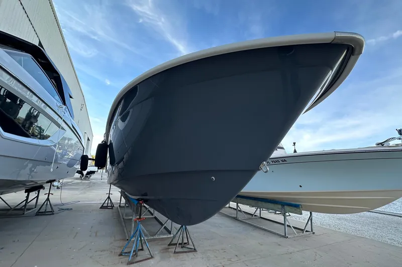 Slide: The Image of 2017 Cape Horn 32 T boat on stands, dockside view under blue sky. - 6