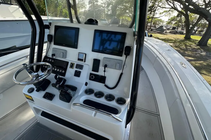 Slide: The Image of 2017 Cape Horn 32 T boat dashboard with steering wheel and navigation screens. - 8