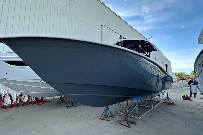 Slide: The Image of 2017 Cape Horn 32 T boat on stands outside a warehouse. - 9