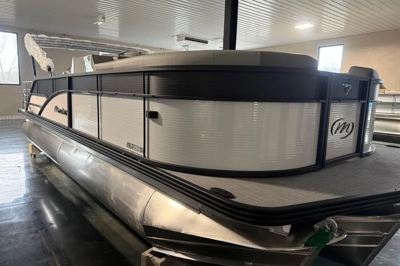 The Image of 2026 Manitou 23 Aurora SL VPII pontoon boat in indoor showroom. - 1