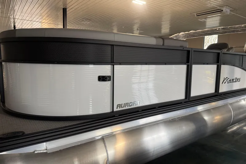 Slide: The Image of 2026 Manitou 23 Aurora SL VPII pontoon boat in a showroom setting. - 3