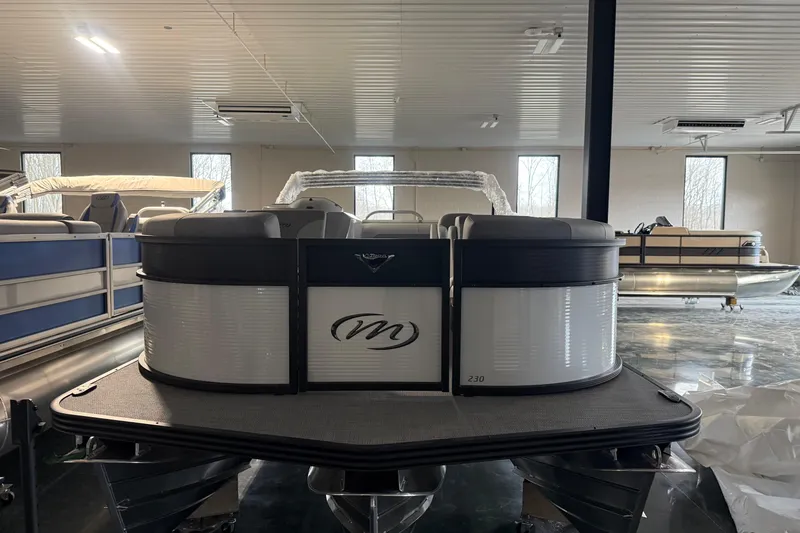 Slide: The Image of 2026 Manitou 23 Aurora SL VPII pontoon boat in showroom, front view. - 6