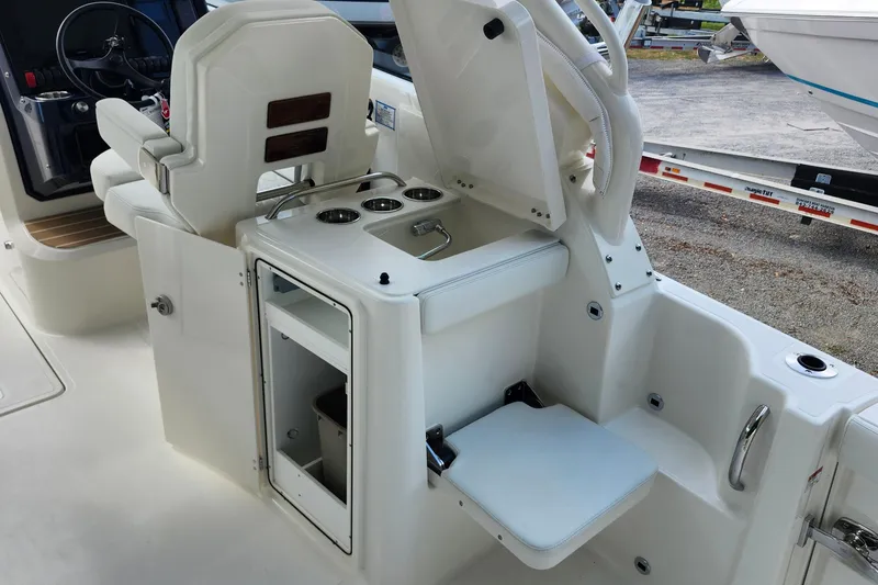 Slide: The Image of 2026 Pursuit DC 286 Dual Console boat interior with seating and storage compartments. - 17