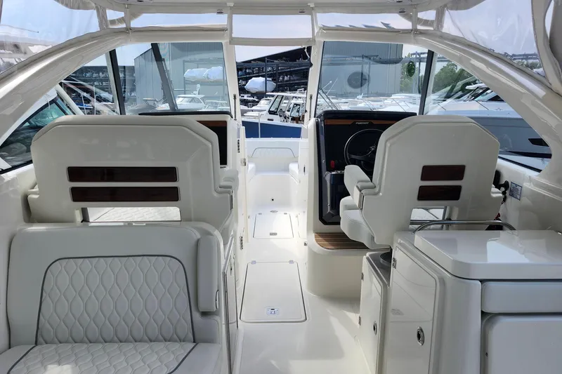 Slide: The Image of Interior view of 2026 Pursuit DC 286 Dual Console boat, featuring sleek seating and helm. - 20