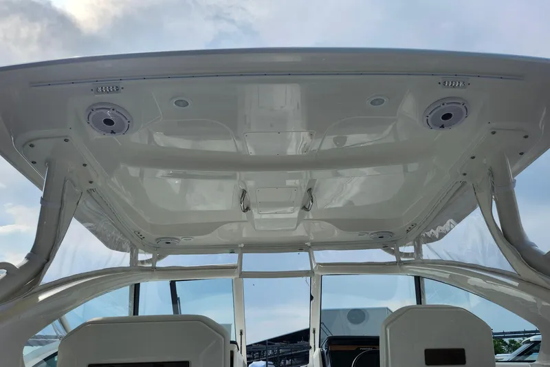 Slide: The Image of 2026 Pursuit DC 286 Dual Console boat interior with speakers and overhead view. - 21