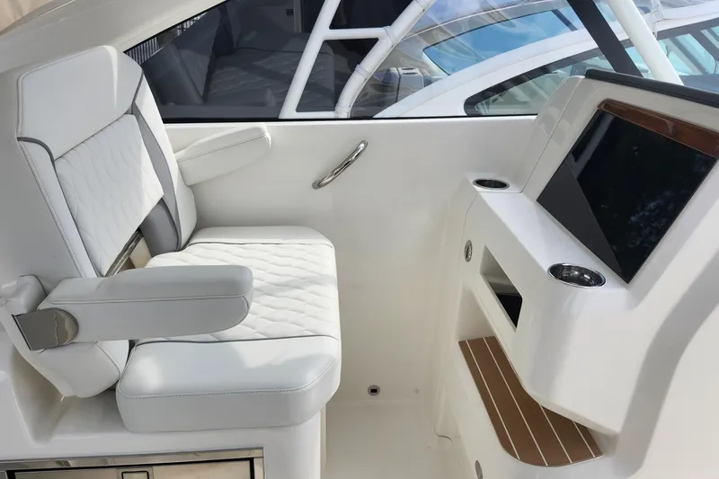 Slide: The Image of Luxurious interior of 2026 Pursuit DC 286 Dual Console boat with white seating and console. - 24