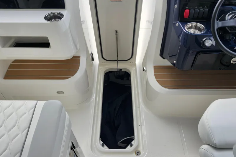 Slide: The Image of 2026 Pursuit DC 286 Dual Console interior with seating and storage compartments. - 27