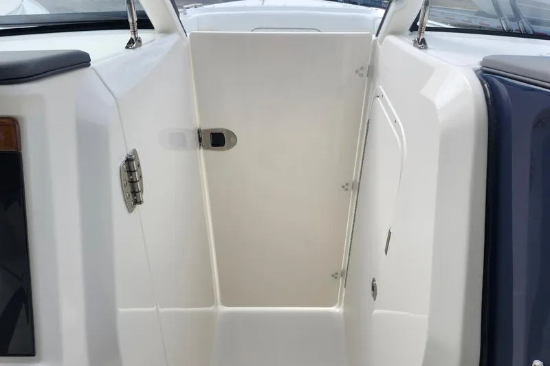 Slide: The Image of 2026 Pursuit DC 286 Dual Console boat interior with open storage compartment. - 28