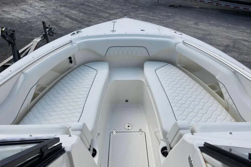Slide: The Image of 2026 Pursuit DC 286 Dual Console boat with white cushioned seating. - 30
