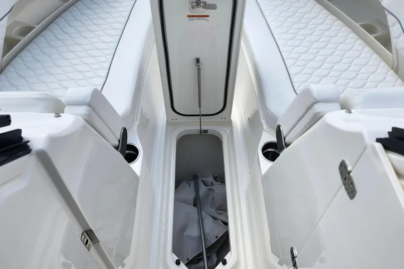 Slide: The Image of 2026 Pursuit DC 286 Dual Console boat interior with open storage compartment. - 31