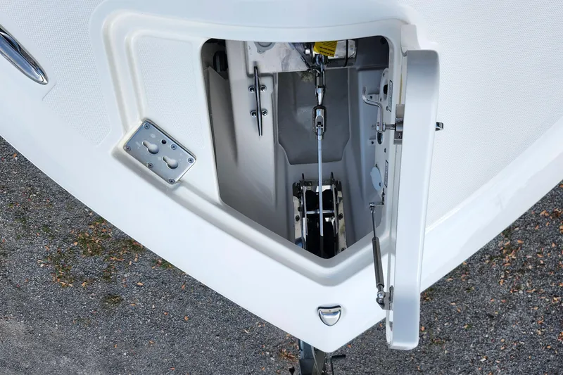 Slide: The Image of 2026 Pursuit DC 286 Dual Console anchor locker with open hatch, showcasing internal mechanisms. - 33