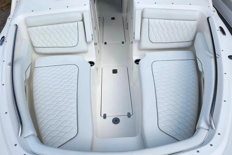 Slide: The Image of 2026 Pursuit DC 286 Dual Console boat interior with white cushioned seating. - 34