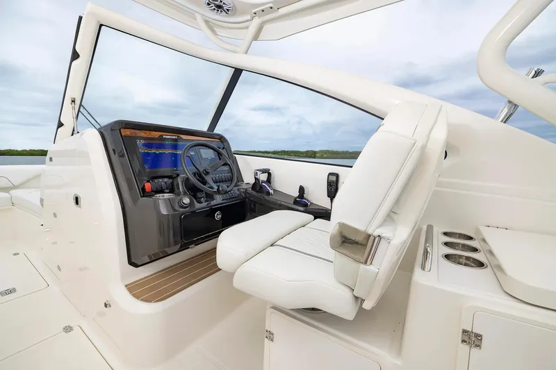 Slide: The Image of Manufacturer Provided Image: 2026 Pursuit DC 286 Dual Console boat interior with modern helm and white seating. - 5
