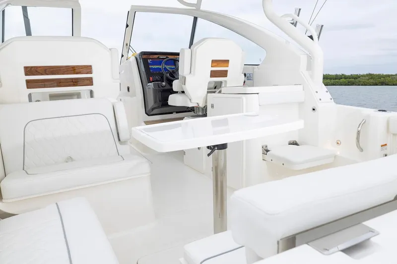 Slide: The Image of Manufacturer Provided Image: 2026 Pursuit DC 286 Dual Console interior with white seating and sleek design. - 9