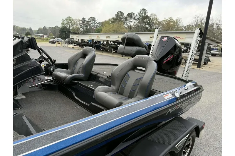 Slide: The Image of 2022 Nitro Z20 boat with dual seats and powerful outboard motor in a dealership lot. - 2