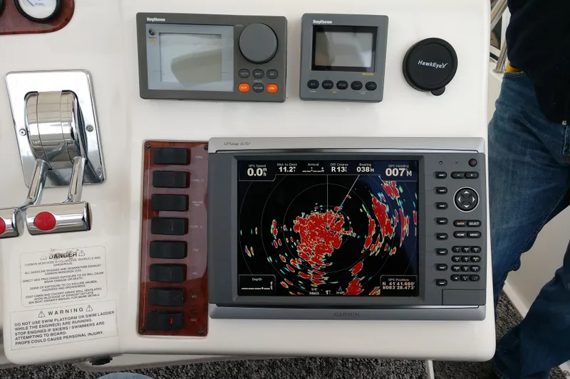 Slide: The Image of Control panel of a 1999 Silverton 422 Motor Yacht with navigation equipment. - 100