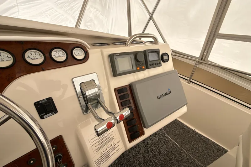 Slide: The Image of 1999 Silverton 422 Motor Yacht helm with Garmin navigation system and control panel. - 16