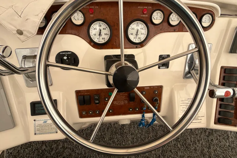 Slide: The Image of 1999 Silverton 422 Motor Yacht helm with gauges and controls. - 17