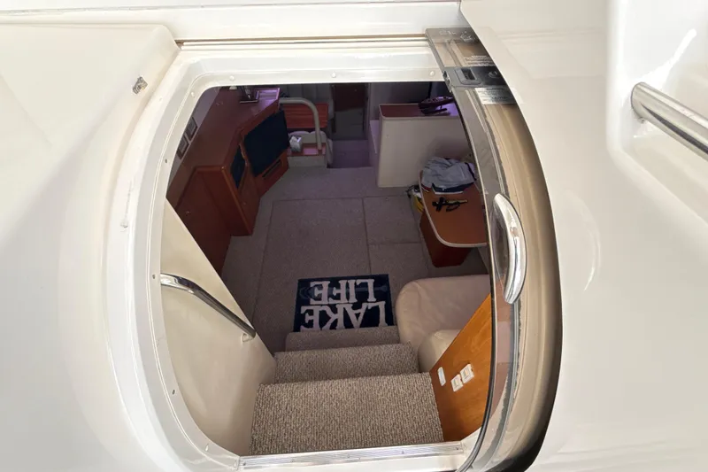 Slide: The Image of Interior view of 1999 Silverton 422 Motor Yacht, showing stairs and cozy cabin area. - 2