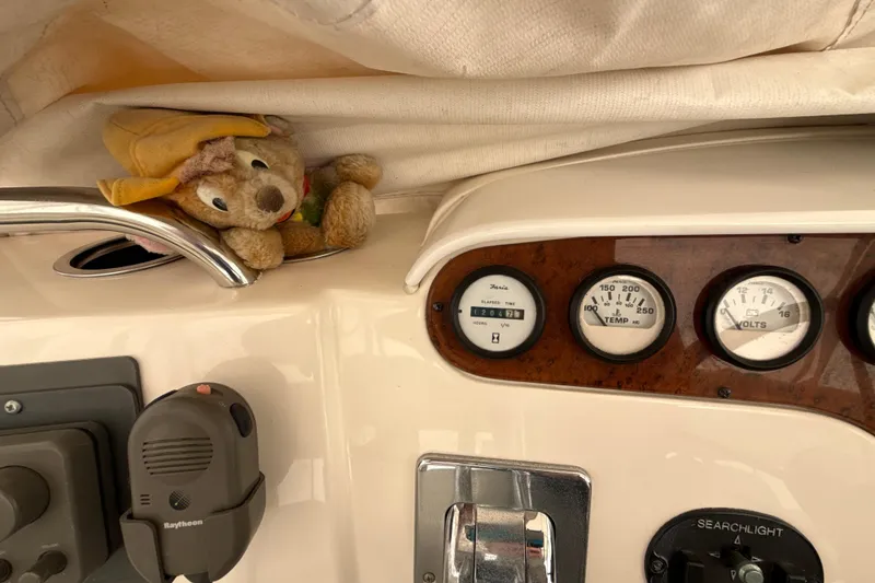 Slide: The Image of 1999 Silverton 422 Motor Yacht dashboard with gauges and a plush toy. - 20