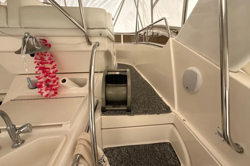 Slide: The Image of Interior of 1999 Silverton 422 Motor Yacht with seating, fan, and decorative lei. - 25