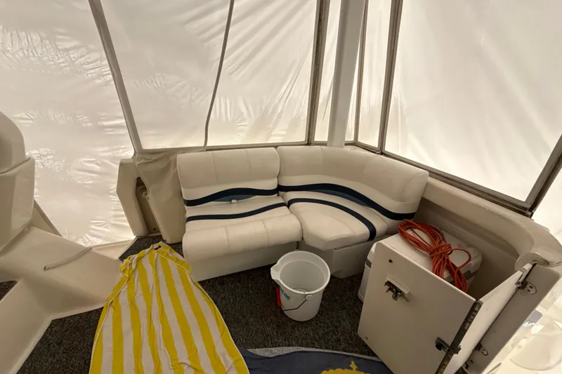 Slide: The Image of Interior of 1999 Silverton 422 Motor Yacht with white seating and nautical decor. - 29