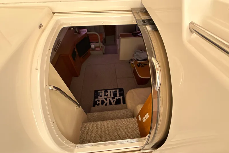 Slide: The Image of Interior view of 1999 Silverton 422 Motor Yacht, showing stairs and cozy cabin area. - 3