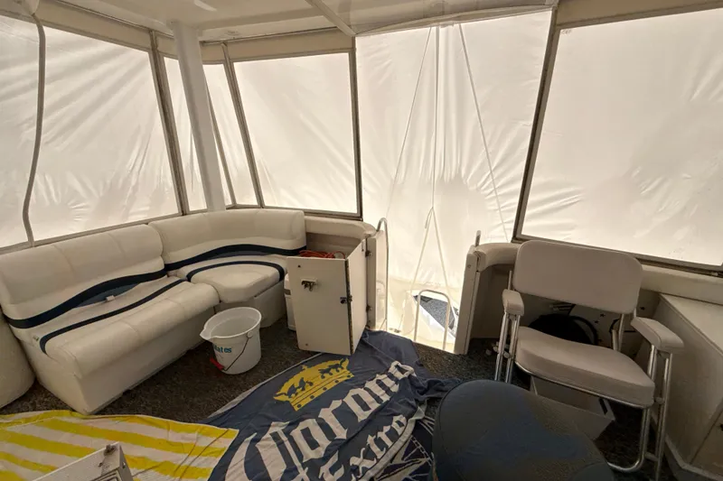 Slide: The Image of 1999 Silverton 422 Motor Yacht interior with white seating and nautical decor. - 30