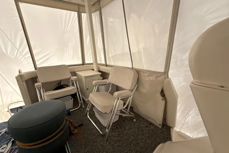 Slide: The Image of 1999 Silverton 422 Motor Yacht interior with beige seating and carpeted floor. - 31