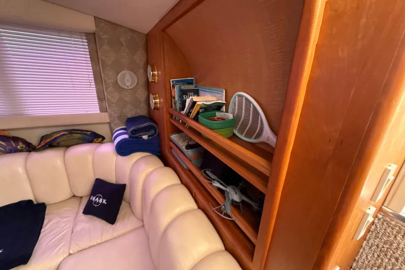 Slide: The Image of Luxurious interior of 1999 Silverton 422 Motor Yacht with plush seating and wooden shelving. - 33