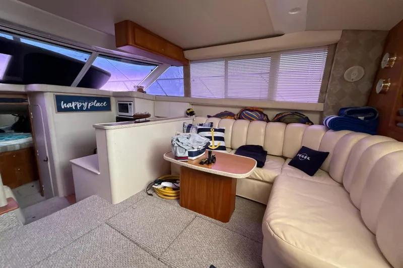 Slide: The Image of Interior of 1999 Silverton 422 Motor Yacht with cozy seating and nautical decor. - 34