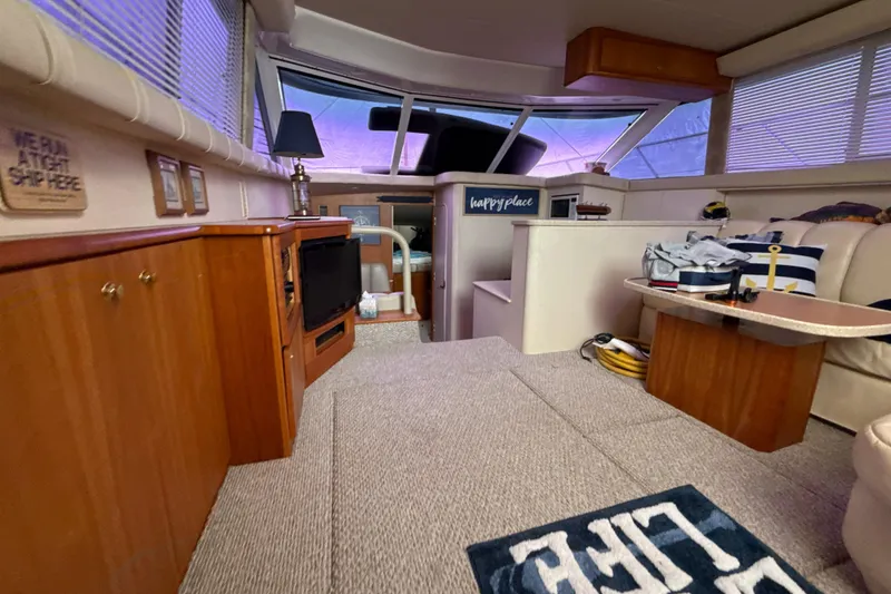 Slide: The Image of Interior of a 1999 Silverton 422 Motor Yacht with cozy seating and nautical decor. - 35