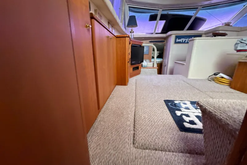 Slide: The Image of Interior of 1999 Silverton 422 Motor Yacht with carpeted flooring and wooden cabinetry. - 36