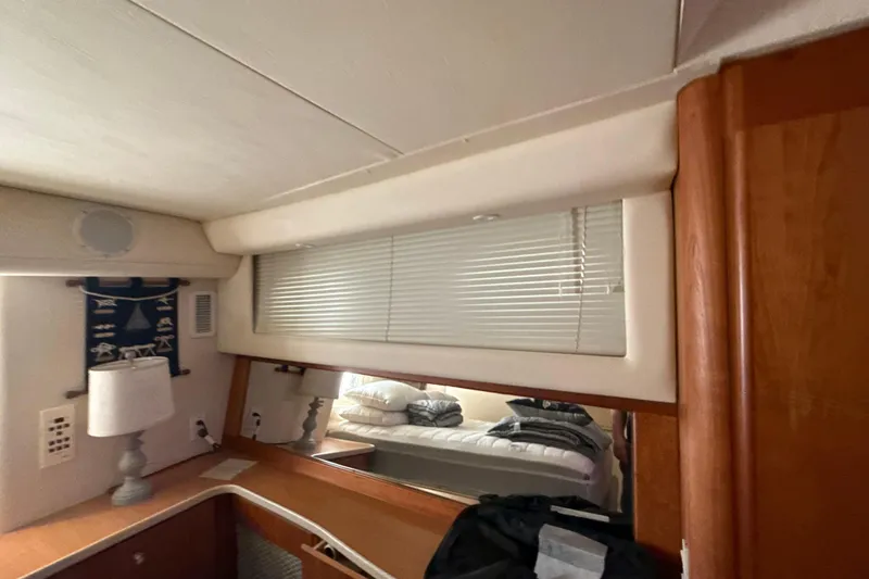 Slide: The Image of Interior of 1999 Silverton 422 Motor Yacht with blinds, lamp, and wooden cabinetry. - 37
